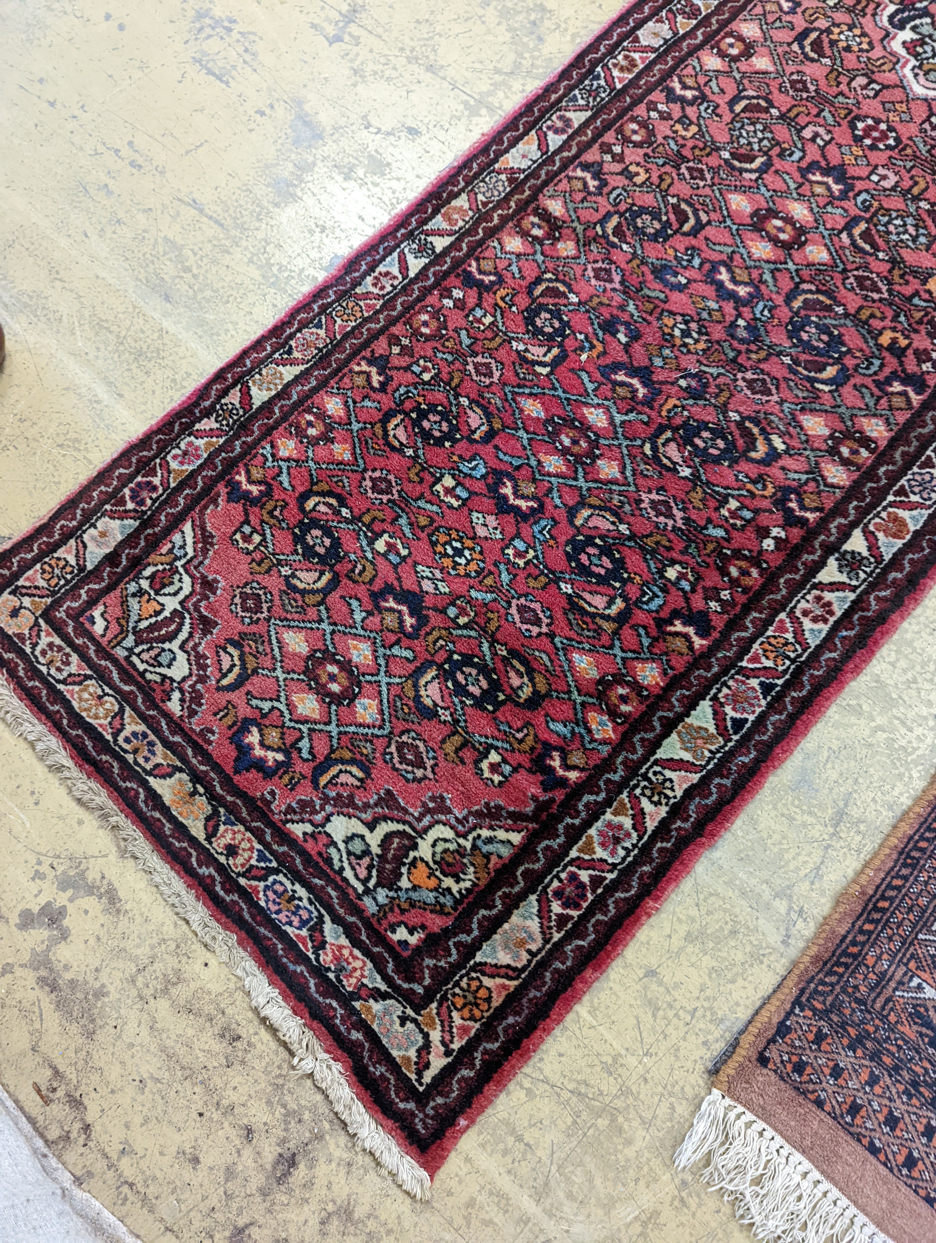 A North West Persian red ground runner and a Bokhara runner, larger approx. 290 x 78cm